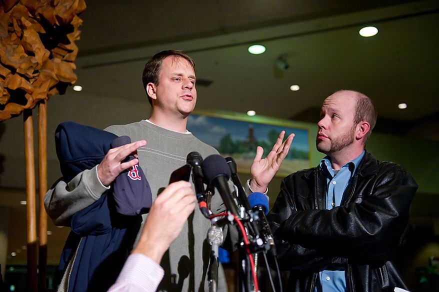 Alternate juror Phil Hosea (right) listens to juror Donny Knepper as he speaks to reporters at the Montgomery County Circuit Court in Rockville, Md., on Nov. 2, 2011, after Lululemon Athletica employee Brittany Norwood is found guilty of killing co-worker Jayna Murray. (Andrew Harnik/The Washington Times)