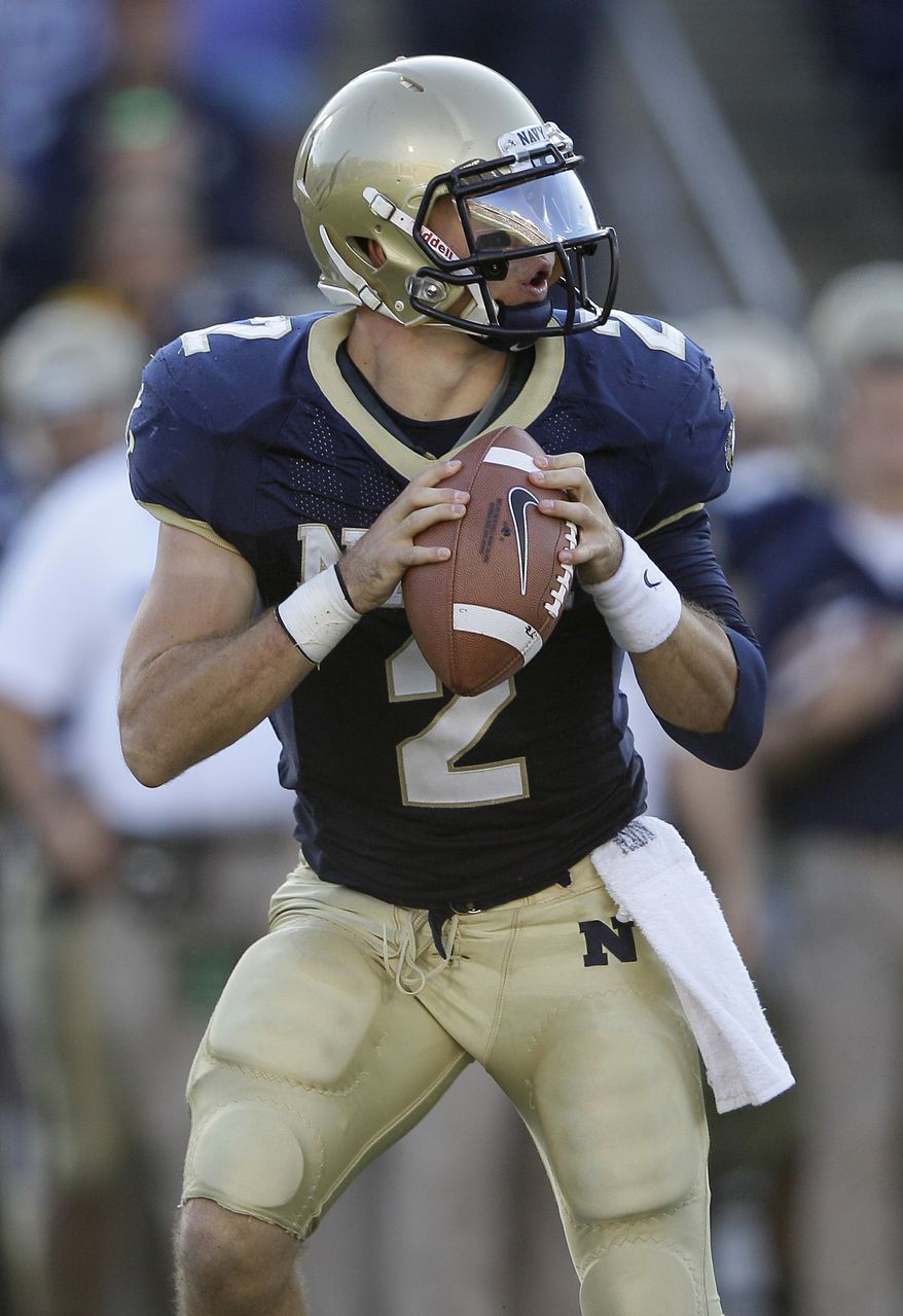 Navy quarterback Kriss Proctor dislocated his elbow Oct. 1 against Air Force, and three weeks later he dislocated it again and could not play last week against Notre Dame. He's doing what it takes to try to get back on the field for Saturday's game against Troy, and Mids coach Ken Niumatalolo is prepared to make a game-time decision, if necessary, on the day's starter. (AP Photo/Patrick Semansky)