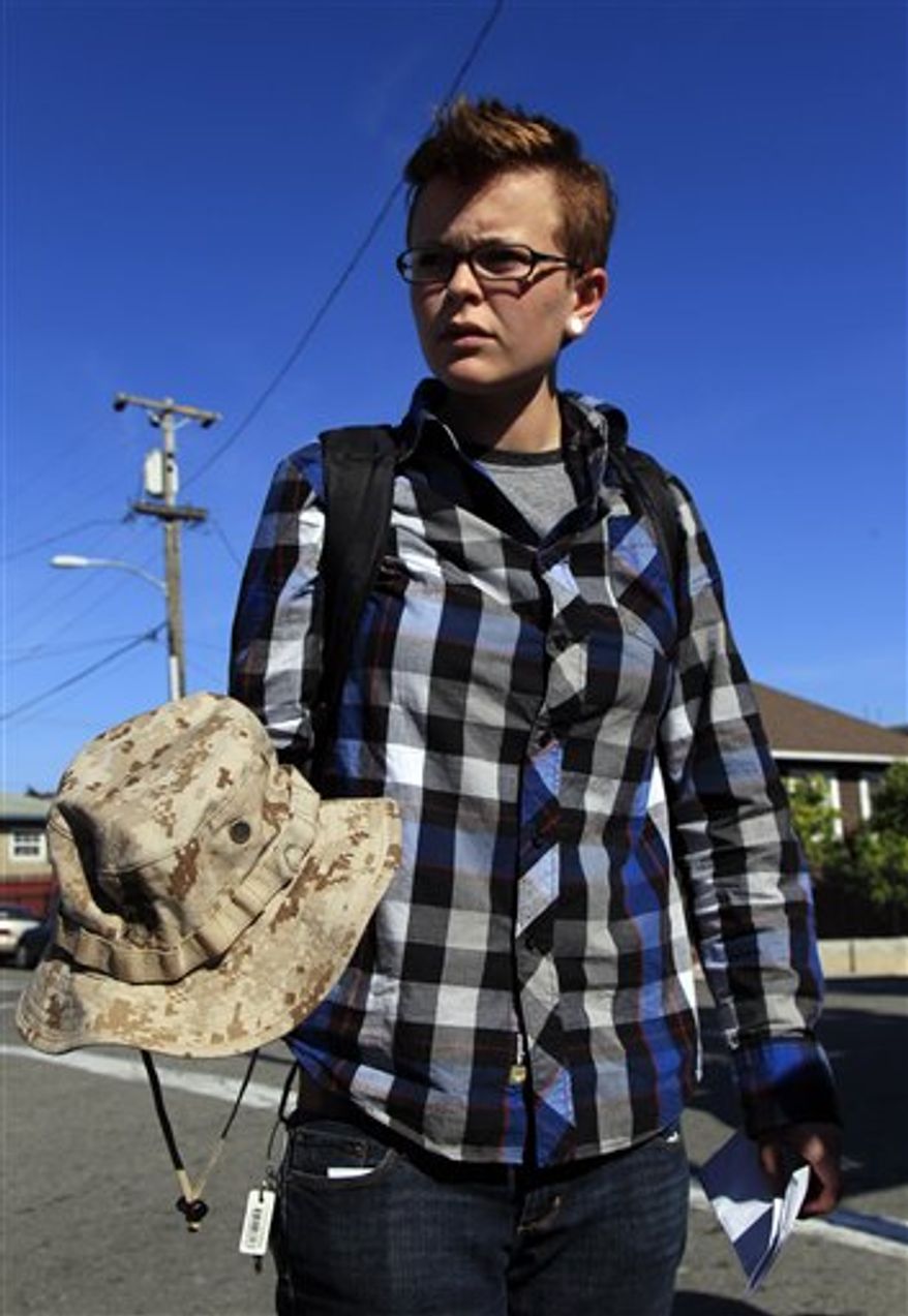Claire Chadwick holds a Marine Corps hat belonging to injured veteran Scott Olsen outside of Highland Hospital, where Olsen is being treated, Thursday, Oct. 27, 2011 in Oakland, Calif. Chadwick was with Olsen when he was injured during confrontations between police and anti-Wall Street demonstrators. Oakland's police chief has pledged a vigorous investigation into a clash between police and Occupy Wall Street protesters that left an Iraq War veteran in critical condition with a fractured skull. (AP Photo/Marcio Jose Sanchez)