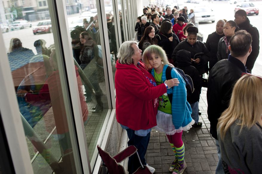 Mary Simpson, of Ruckersville, Va., center, hugs her daughter Kat, 13, while waiting in line to audition for America's Got Talent at the Walter E. Washington Convention Center in Washington, D.C. on Nov. 6, 2011.
(T.J. Kirkpatrick/ The Washington Times)
