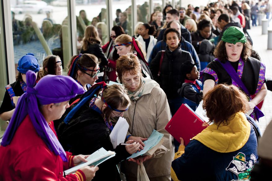 Rodd Chin, at left, watches Carin Diggle, at center, go over registration paperwork with her daughter Kalla, 14, while Brandon Nestor, 13, right, waits in line with the Japanese Taiko drum troupe from Chin's Hamaya Culture Center in Charlotte Hall, Md., during auditions for America's Got Talent.
(T.J. Kirkpatrick/ The Washington Times)