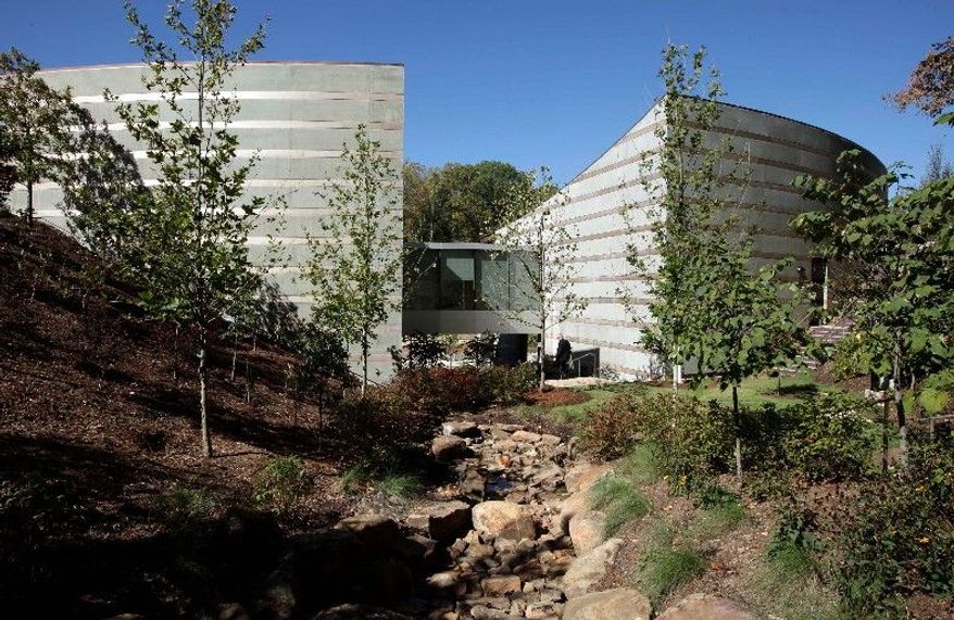 Sections of the museum sit amid a tree-lined ravine in Bentonville, Ark. The museum is a 10-minute walk through the woods from Bentonville's downtown square, on 120 acres owned by the Walton family.