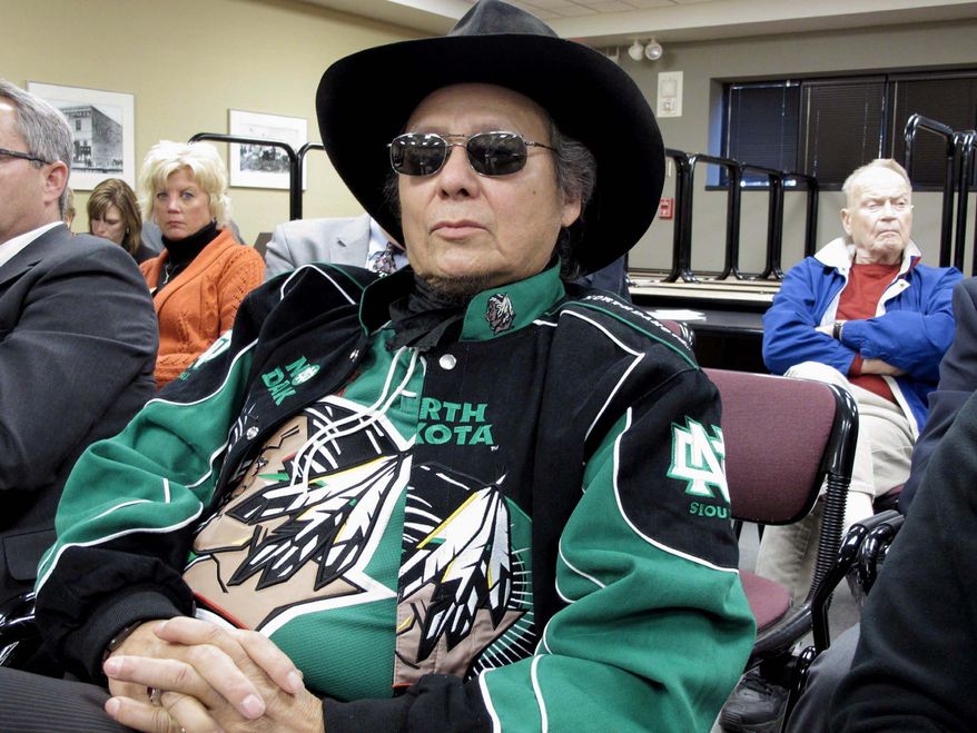 Samuel Seaboy, of Mandan, N.D., listens to testimony on Monday at the North Dakota Capitol in Bismarck about legislation that would allow the University of North Dakota to drop its Fighting Sioux nickname and an American Indian head logo. Mr. Seaboy said he opposed the bill. (Associated Press)