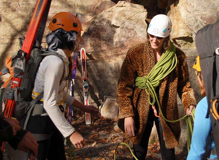 In this photo taken Oct. 28, 2011 and released by Ascent Services Worldwide LLC, Margaret Wheeler, center, president of the American Mountain Guides Association, and executive director Betsy Winter, left, prepare for an event in Guide's Olympics during the association's annual conference at the Shawangunk climbing area in New Paltz, N.Y. (AP Photo/Ascent Services Worldwide LLC, Joe Lentini)