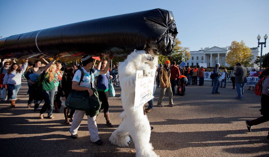 Demonstrators march with a replica pipeline outside the White House on Sunday to protest TransCanada&#39;s proposed Keystone XL pipeline. Citing environmental fears, the State Department on Thursday ordered a new review of the Canada-to-Texas pipeline. (Associated Press)