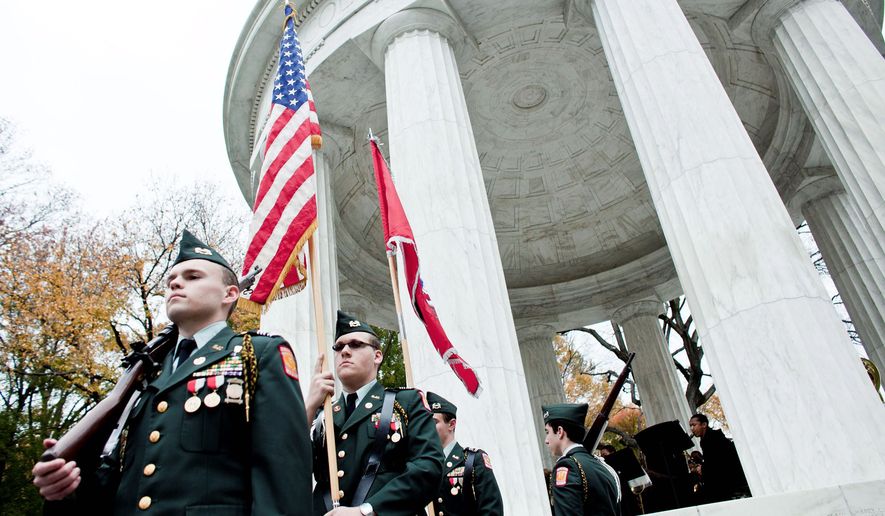 HONOR GUARD: Alexander Hubichi (from left), Matthew Cranford, Thomas Shedlick, and Matthew Shipley, Army JROTC cadets at St. John&#39;s College High School, carry the colors Thursday at the District of Columbia War Memorial. (T.J. Kirkpatrick/The Washington Times)