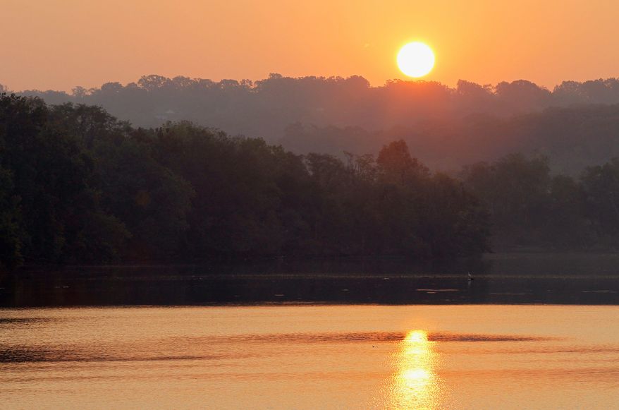 The sun rises over Oxon Cove Park and is reflected in a Potomac River estuary in Oxon Hill. Water quality in the Potomac was already bad and has grown worse in the past five years, a Potomac Conservancy report said Thursday. (Associated Press)