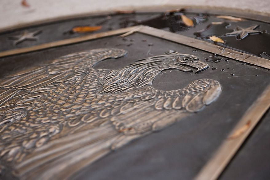 A bronze plaque was specially recreated to replace a missing plaque at the center of the District of Columbia WWI Memorial as part of the memorial's renovation, seen during a rededication ceremony in Washington, D.C. on Nov. 10, 2011. The National Park Service did not have records of the exact design on the original plaque, with the exception of the design including an image of an eagle, but made the replacement to mesh with the marble patterns on the floor.
(T.J. Kirkpatrick/ The Washington Times)