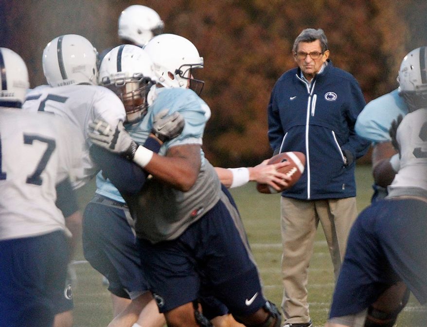 Penn State coach Joe Paterno watches his football team practice on Wednesday, Nov. 9, 2011, in State College, Pa. Paterno, who preached success with honor for a half-century but whose legend was shattered by a child-sex-abuse scandal, said Wednesday that he would retire at the end of the season. (AP Photo/Matt Rourke)