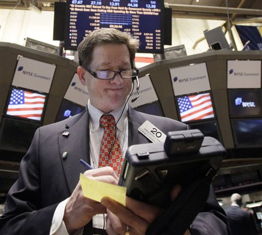 In this Nov. 10, 2011 photo, trader Christopher Forbes works on the floor of the New York Stock Exchange. The prospect of new governments in Greece and Italy helped support market sentiment Friday, Nov. 11, 2011, at the end of a hugely-volatile week when investors fretted over the future of the euro currency and the outlook for the global economy. (AP Photo/Richard Drew)