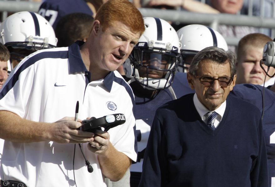 ** FILE ** In this Oct. 8, 2011, file photo, Penn State assistant football coach Mike McQueary, left, talks with head coach Joe Paterno during an NCAA college football game against Iowa, in State College, Pa. (AP Photo/Gene Puskar, File)