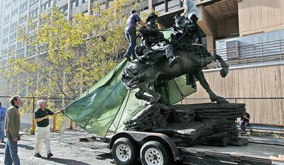 Artist Douwe Blumberg, left, watches as a tarp is removed from his &quot;De Opresso Liber&quot; statue, Thursday, Nov. 10, 2011, in New York. The 16-foot bronze statue honoring the U.S. special operations response to 9/11 was expected to be unveiled Nov. 11, 2011, by Vice President Joe Biden and Dr. Jill Biden. (AP Photo/Mary Altaffer)