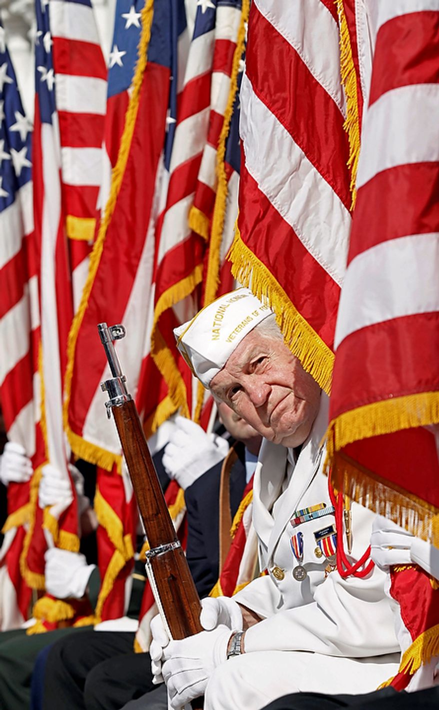 A member of the National Honor Guard looks out to listen to President Barack Obama as he spoke during a Veteranís Day ceremony at Arlington National Cemetery in Arlington, Va., Friday, Nov. 11, 2011. (AP Photo/Pablo Martinez Monsivais)