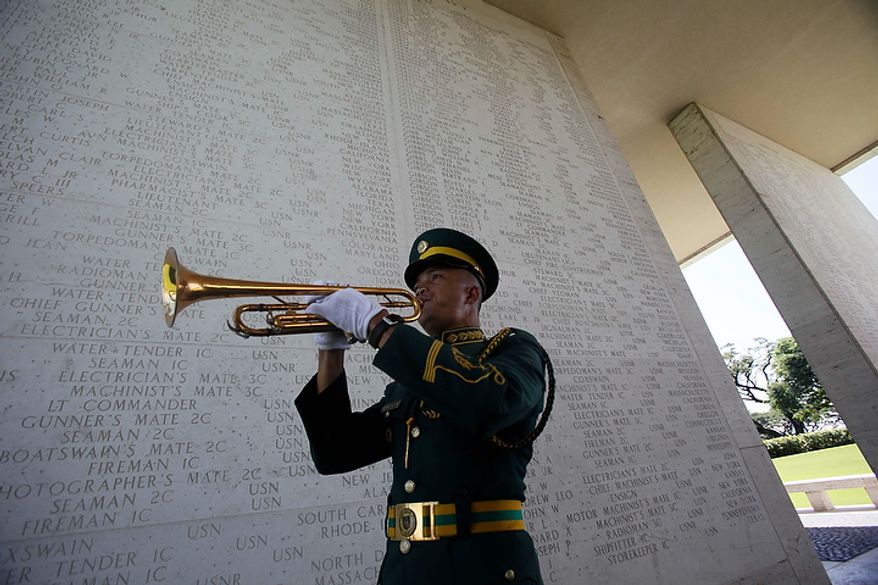 Philippine army Pfc. Enrico Disimulacion plays the Taps during wreath-laying ceremony at the American Cemetery and Memorial at suburban Taguig city, east of Manila, Philippines, to pay tribute to U.S. veterans and their families on Veterans Day Friday, Nov. 11, 2011. The Manila American Cemetery and Memorial contains the remains of WWII Americans who died in the Pacific, China, India, and Burma along with Philippine Scouts who served with the U.S. forces. (AP Photo/Bullit Marquez)