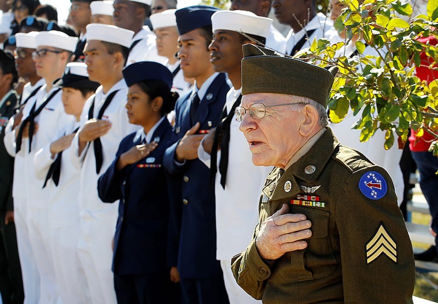 Korean War veteran James Gerard, right, wearing his original uniform, salutes during a Veteran's Day observance at Fort Sam Houston National Cemetery, Friday, Nov. 11, 2011, in San Antonio. (AP Photo/Eric Gay)
