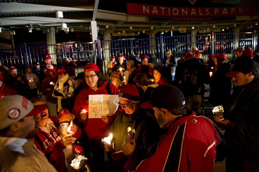 Nationals fans gather in a circle and trade stories during a candlelight vigil for Nationals' rookie catcher Wilson Ramos at Nationals Park in Washington, DC, Friday, November 11, 2011. Ramos was kidnapped by armed gunmen in front of his family home in Venezuela on Wednesday night. (Rod Lamkey Jr. / The Washington Times)