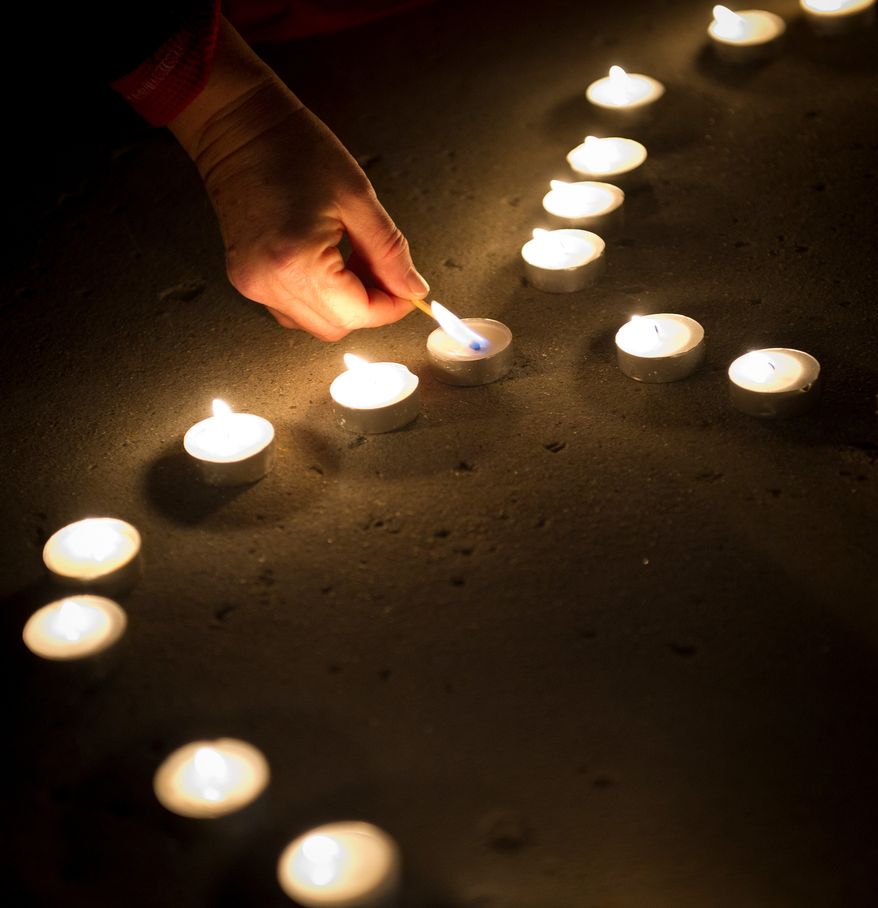 Votive candles laid out in the pattern of the letter "W" are lit during a candlelight vigil for Nationals' rookie catcher Wilson Ramos at Nationals Park in Washington, DC, Friday, November 11, 2011. . Ramos was kidnapped by armed gunmen in front of his family home in Venezuela on Wednesday night. (Rod Lamkey Jr. / The Washington Times)