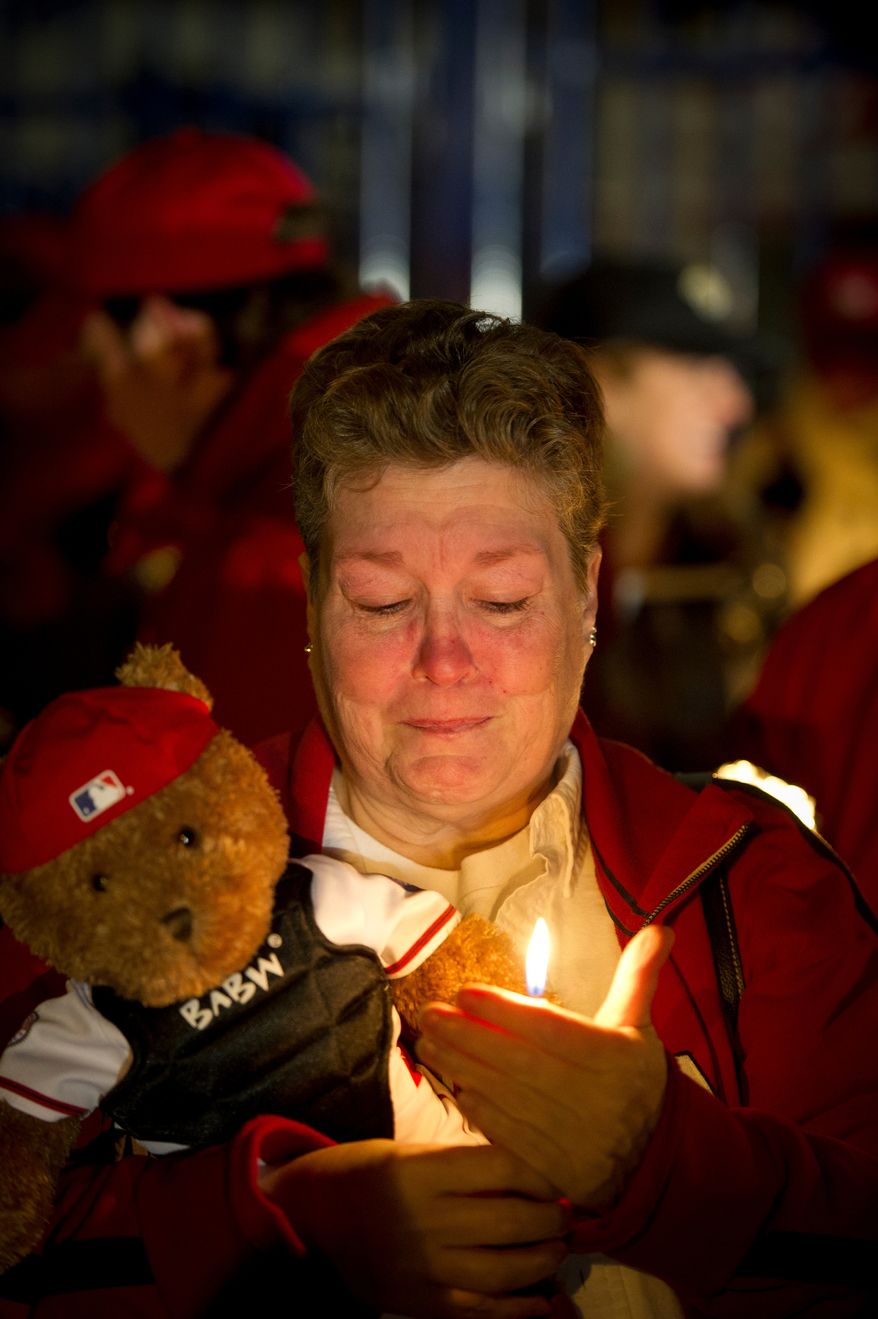 Mary Brick of Centreville, Va, gets emotional as she holds a teddy bear and a candle during a candlelight vigil for Nationals' rookie catcher Wilson Ramos at Nationals Park in Washington, DC, Friday, November 11, 2011. Ramos was kidnapped by armed gunmen in front of his family home in Venezuela on Wednesday night. (Rod Lamkey Jr. / The Washington Times)