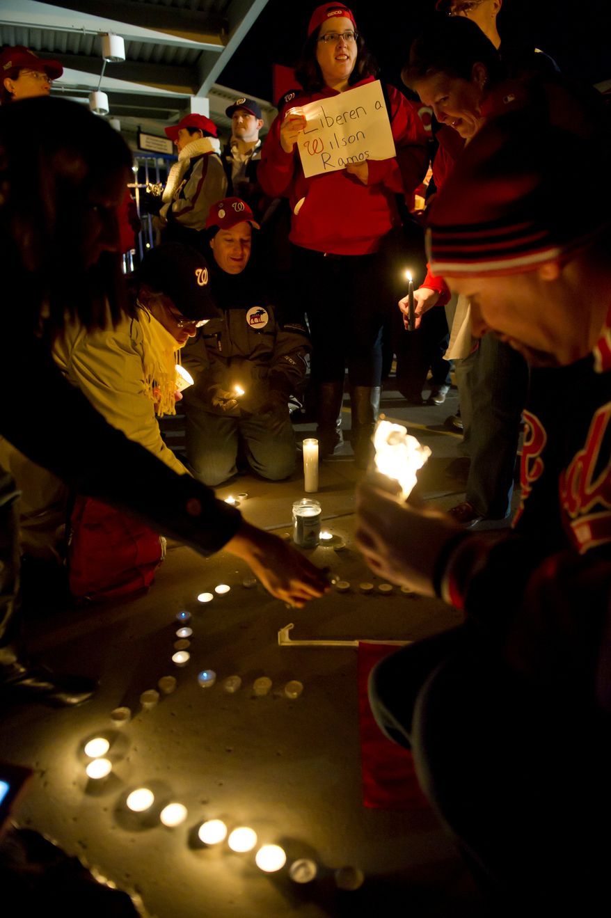Votive candles laid out in the pattern of the letter "W" are lit during a candlelight vigil for Nationals' rookie catcher Wilson Ramos at Nationals Park in Washington, DC, Friday, November 11, 2011. Ramos was kidnapped by armed gunmen in front of his family home in Venezuela on Wednesday night. (Rod Lamkey Jr. / The Washington Times)
