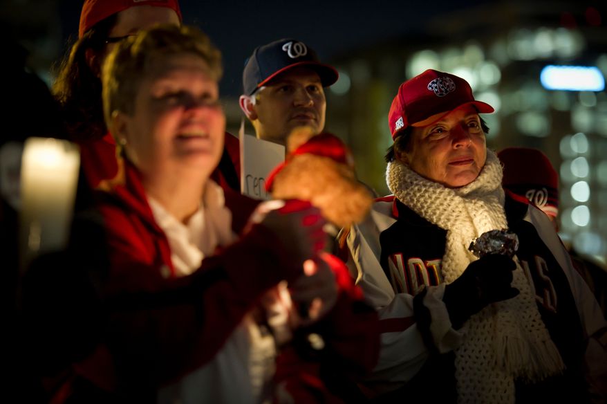Olga Stopher (right) joins other Nationals fans during a candlelight vigil for Nationals' rookie catcher Wilson Ramos at Nationals Park in Washington, DC, Friday, November 11, 2011. Ramos was kidnapped by armed gunmen in front of his family home in Venezuela on Wednesday night.(Rod Lamkey Jr. / The Washington Times)