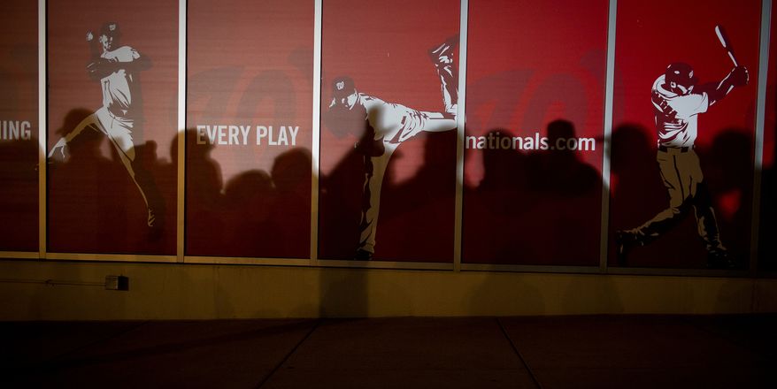 The shadows of Nationals fans flitter on a wall during a candlelight vigil for Nationals' rookie catcher Wilson Ramos at Nationals Park in Washington, DC, Friday, November 11, 2011. Ramos was kidnapped by armed gunmen in front of his family home in Venezuela on Wednesday night. (Rod Lamkey Jr. / The Washington Times)