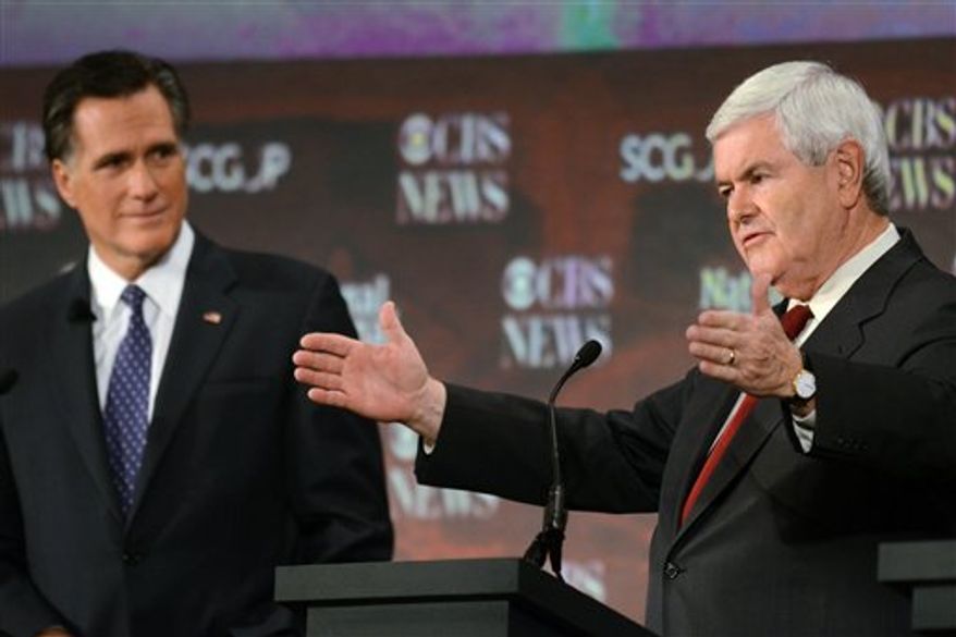 Republican presidential candidates Newt Gingrich (left) and former Massachusetts Gov. Mitt Romney participate in the CBS News/National Journal foreign policy debate at the Benjamin Johnson Arena in Spartanburg, S.C., on Nov. 12, 2011. (Associated Press)