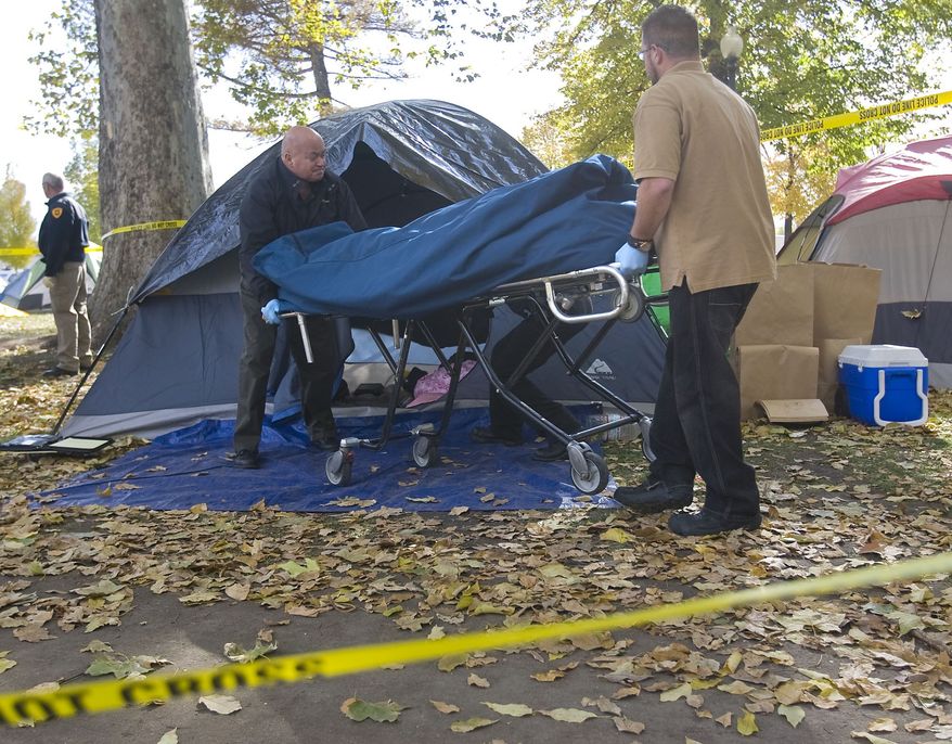 A body is removed from a tent in the Occupy Salt Lake camp in Pioneer Park, Friday Nov. 11, 2011, in Salt Lake City. (AP Photo/The Salt Lake Tribune, Al Hartmann)