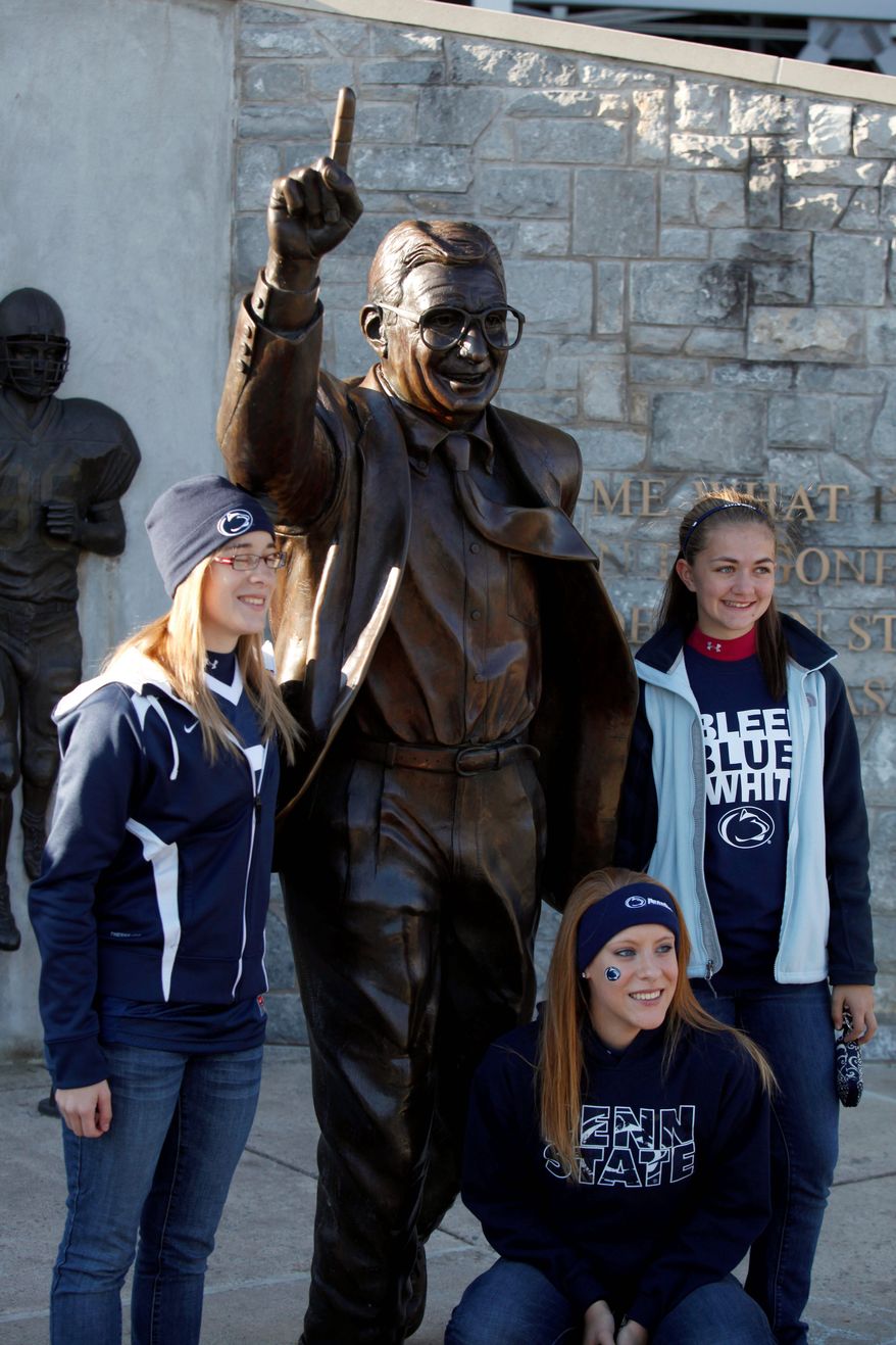 The statue of Joe Paterno outside Beaver Stadium remains a popular attraction on Penn State's campus. Fans expressed views in support of the college football coaching icon and in support of the victims of the child sexual abuse that allegedly occurred under Paterno's watch. (Associated Press)