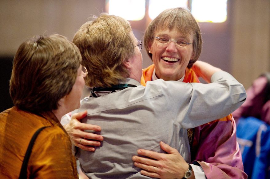Bishop Mariann Edgar Budde greets a churchgoer after a service Sunday at the National Cathedral. The 51-year-old was installed Saturday as the ninth bishop of the Washington Episcopal Diocese. (Andrew Harnik/The Washington Times)