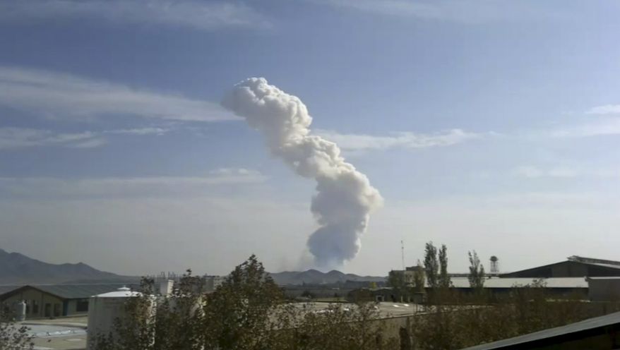 In this image taken from amateur video, smokes rises from an accidental explosion at a Revolutionary Guard ammunition depot outside Bidganeh village, west of Tehran which killed at least 15 people on Nov. 12, 2001, officials said. (Associated Press)