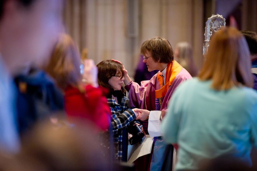 The Reverend Dr. Mariann Edgar Buddle, right, the newly seated ninth bishop of Washington, greets a member of the congregation following the service of Holy Eucharist. (Andrew Harnik / The Washington Times)