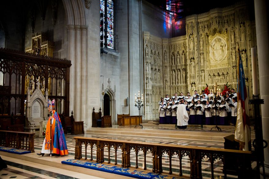 The Reverend Dr. Mariann Edgar Buddle makes her way to the main alter after being seated as the ninth bishop of Washington. (Andrew Harnik / The Washington Times)