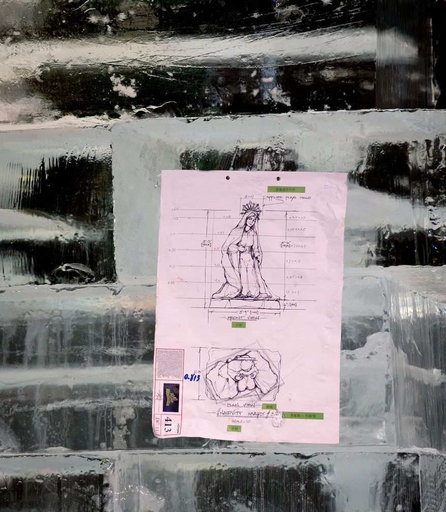 A guide on paper for the design of a portion of a Nativity scene is attached to a wall of ice for artisan ice sculptors to go by in their work on the 100-acre exhibit at Gaylord National Resort & Convention Center. The third annual exhibition opens Friday. (Rod Lamkey Jr./The Washington Times)