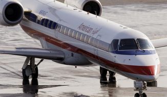 **FILE** An American Eagle jet taxis at Boston&#39;s Logan International Airport on Jan. 20, 2011. (Associated Press)