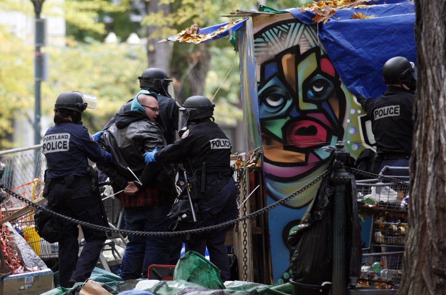 Police officers arrests a protester in the Occupy Portland encampment on Nov. 13, 2011, in, Portland, Ore. (Associated Press)