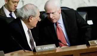 ** FILE ** Sen. Carl Levin (left), Michigan Democrat, chats with Sen. John McCain, Arizona Republican, during a hearing of the Senate Armed Services Committee on Tuesday, Nov. 15, 2011. (T.J. Kirkpatrick/The Washington Times)