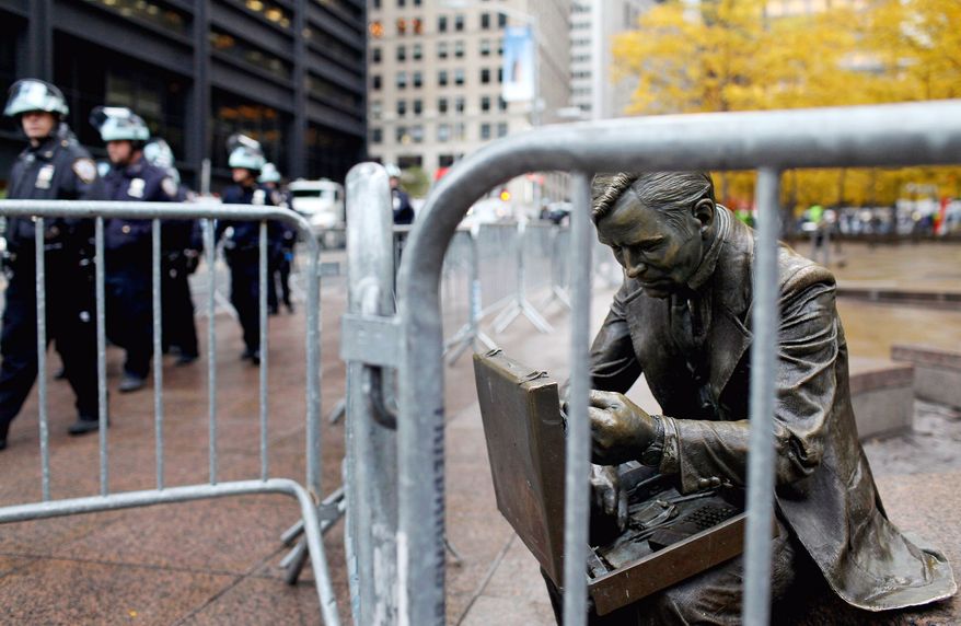 A police barricade around Zuccotti Park keeps Occupy Wall Street protesters away from the site of their former encampment in New York after the encampment was cleared out and cleaned Tuesday morning, ending a nearly two-month occupation.