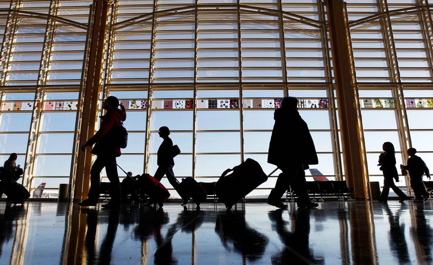 A new survey of nearly 4,400 U.S. air travelers, such as these at Ronald Reagan Washington National Airport, found that most named "people who bring too many carry-on bags through the security checkpoint" as their top frustration. (Associated Press)