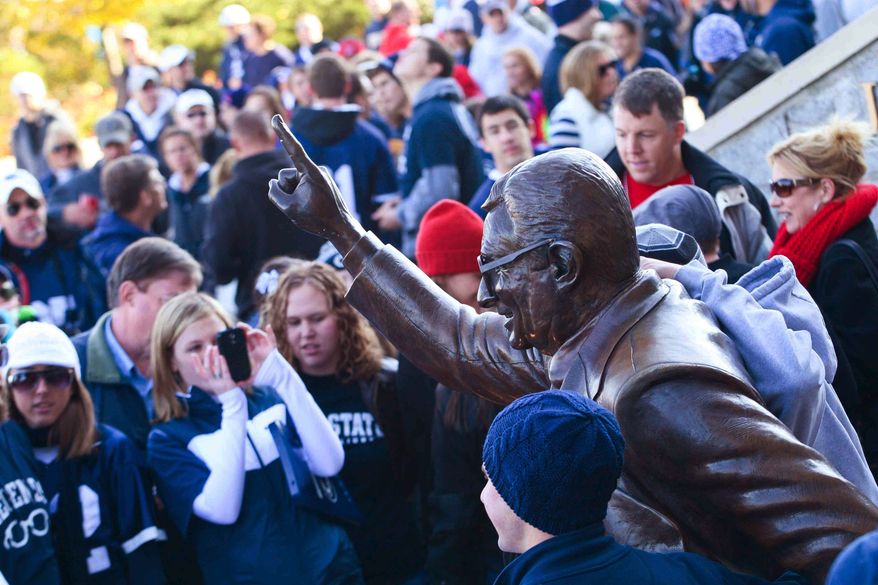 Penn State fans gather outside Beaver Stadium to get a picture next to Joe Paterno's statue before the game between Penn State and Nebraska Saturday, Nov. 12, 2011 in State College, Pa. (AP Photo/The Wilmington News-Journal, Suchat Pederson)