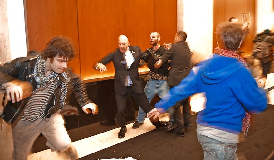 Demonstrators with Occupy D.C. are forcibly removed from the lobby of the Victor Building during a march in downtown Washington, D.C., Tuesday, Nov. 15, 2011, to show support for the Occupy Wall Street movement. (Rod Lamkey Jr./The Washington Times)
