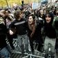 Protesters jump on police barricades on Thursday, Nov. 17, 2011, in New York&#x27;s Zuccotti Park, where the Occupy Wall Street movement began two months earlier. Demonstrators from coast to coast joined their call for economic justice. (Associated Press)