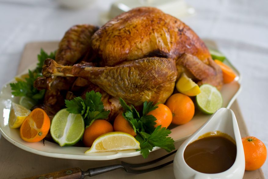 Soy sauce is the secret to a perfectly browned turkey. Citrus zest added to the sauce, plus orange and lemon in the cavity while roasting, add flavor. (Associated Press)