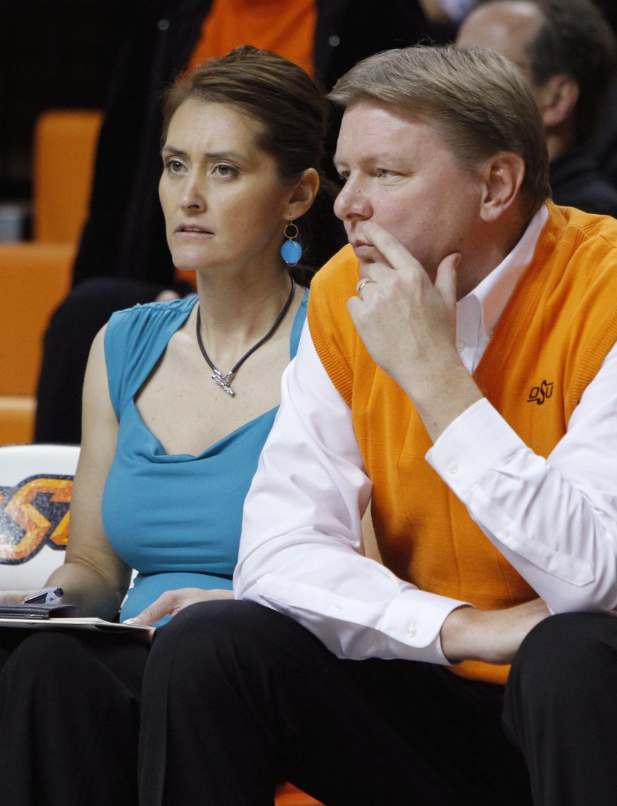 This Nov. 9, 2011 photo shows Oklahoman State women's basketball coach Kurt Budke and assistant coach Miranda Serna during an an exhibition women's NCAA college basketball game against Fort Hays State, in Stillwater, Okla. Budke and Serna were killed when the single-engine plane they were riding in during a recruiting trip crashed near a wildlife management area in central Arkansas. The university said the pair died in the crash Thursday night, Nov. 17, 2011. (AP Photo/The Oklahoman, Bryan Terry)