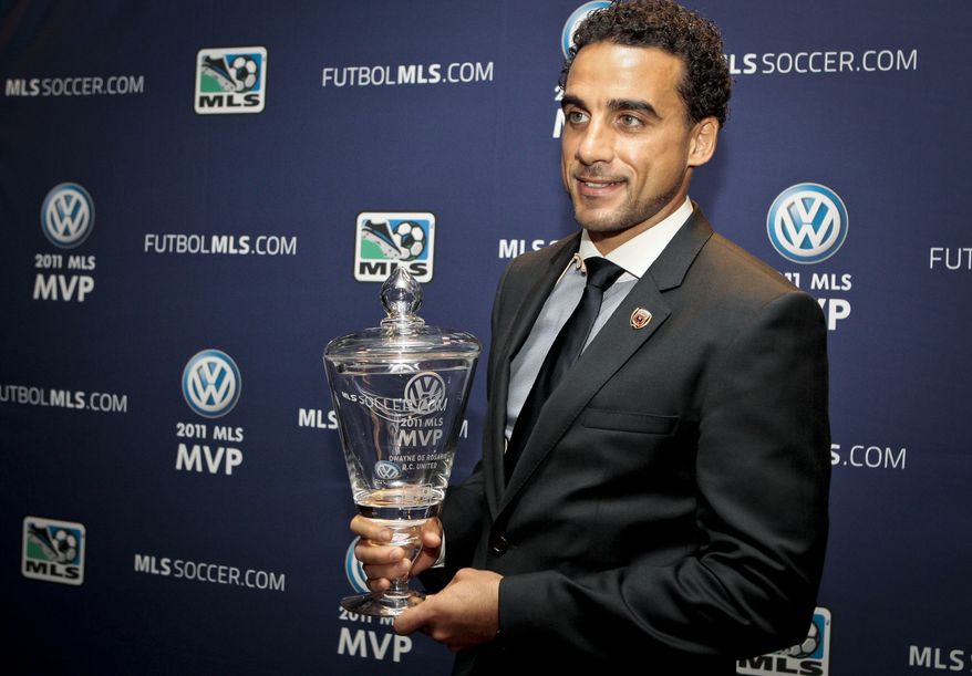 ** FILE ** D.C. United midfielder Dwayne De Rosario holds the MLS Most Vaulable Player trophy during a news conference on Friday, Nov. 18, 2011, in Carson, Calif. (AP Photo/Bret Hartman)
