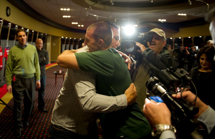 Wilson Ramos greets teammate Steve Lombardozzi in the Nationals clubhouse after a brief press conference. Lombardozzi had been at Nationals Park working out.