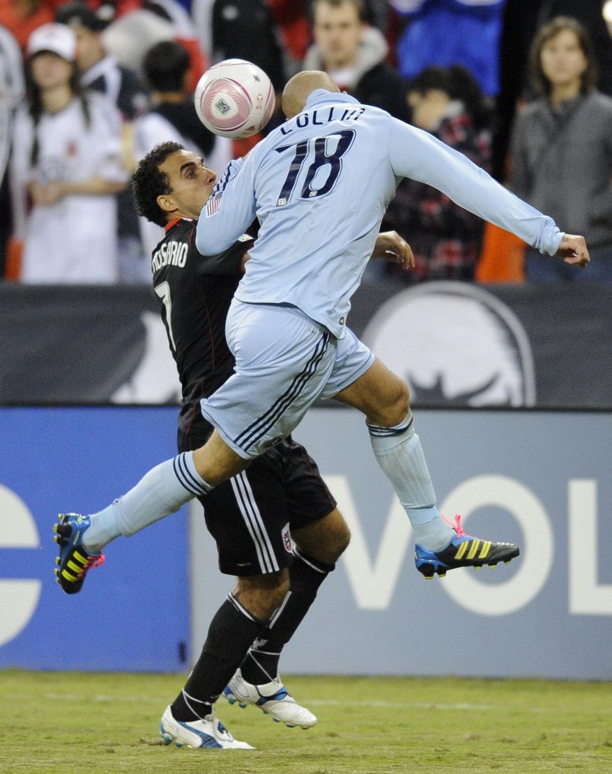 D.C. United's Dwayne De Rosario, left, battles for the ball against Sporting Kansas City defender Aurelien Collin, right, during the second half of an MLS soccer game, Saturday, Oct. 22, in Washington. Kansas City won 1-0. (AP Photo/Nick Wass)