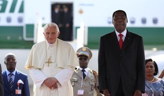 Pope Benedict XVI stands with Benin&#39;s President Yayi Boni during an airport welcome ceremony in Cotonou, Benin Friday, Nov. 18, 2011. (AP Photo/Rebecca Blackwell)