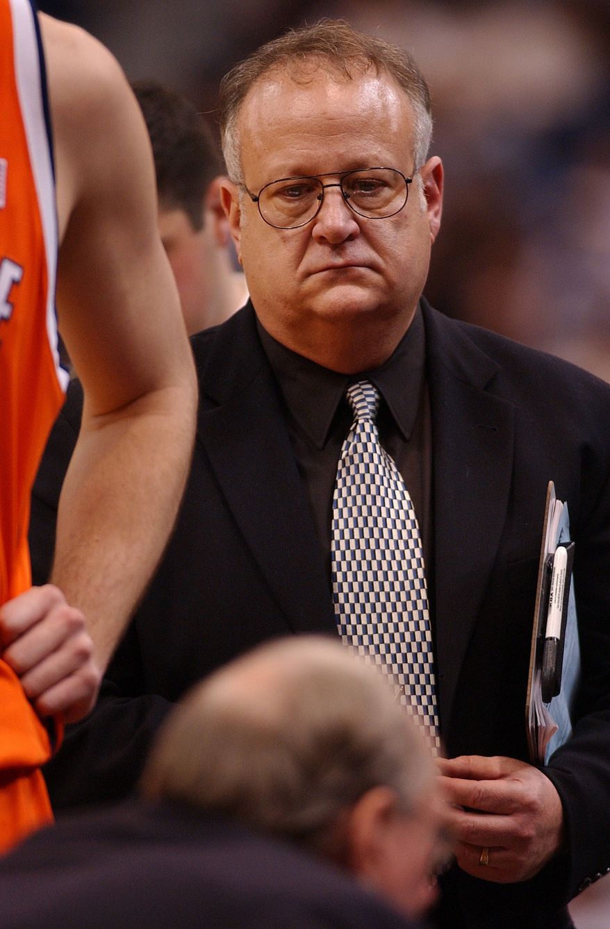 This Feb. 10, 2003 photo shows Syracuse assistant basketball coach Bernie Fine during a game against the University of Connecticut, in Hartford, Conn. Fine was placed on administrative leave Thursday, Nov. 17, 2011 after old child molesting allegations resurfaced, just two weeks after a child sex abuse scandal rocked Penn State. (AP Photo/The Post-Standard, Stephen D. Cannerelli)
