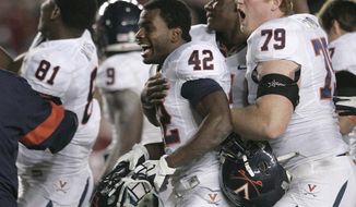 Virginia players celebrate their 14-13 victory over Florida State on Saturday, Nov. 19, 2011, in Tallahassee, Fla.(AP Photo/Steve Cannon)