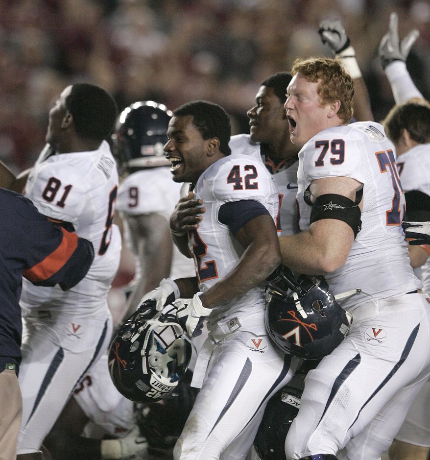 Virginia players celebrate their 14-13 victory over Florida State on Saturday, Nov. 19, 2011, in Tallahassee, Fla.(AP Photo/Steve Cannon)